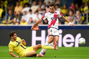 VILLARREAL, SPAIN - NOVEMBER 01: Santi Comesana of Villarreal CF tackles Pedro Diaz of Rayo Vallecano during the LaLiga EA Sports match between Villarreal CF and Rayo Vallecano de Madrid at Estadio de la Ceramica on November 01, 2025 in Villarreal, Spain. (Photo by Alex Caparros/Getty Images)